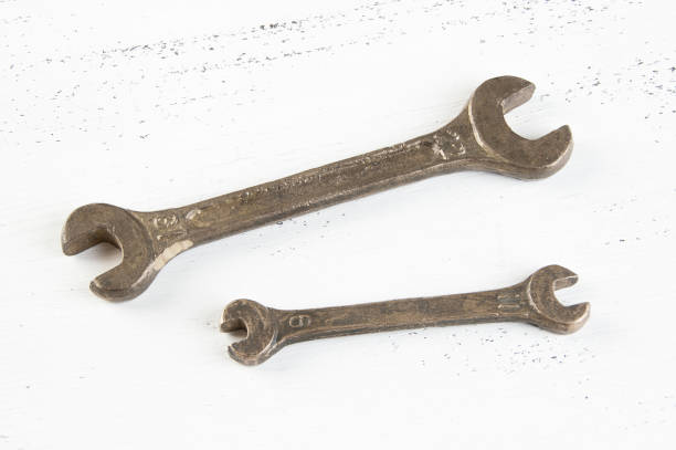 istock Vintage bronze wrenches on shabby background 1063270606