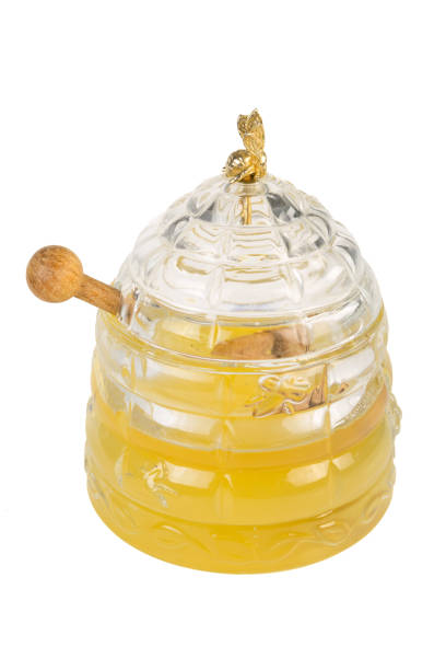 istock Luxury Honey pot with honey comb cut out on a white background 1063280660