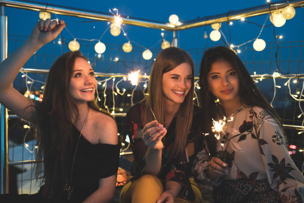 istock Female friends partying on the rooftop 1063282318