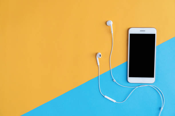 istock Top view, Modern workplace with smartphone placed on pastel background. Copy space suitable for use in graphics. 1063286314