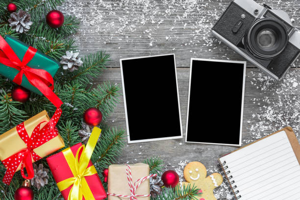 istock Christmas photo frames with retro camera, fir branches, decorations, gift boxes and pine cones 1063286774