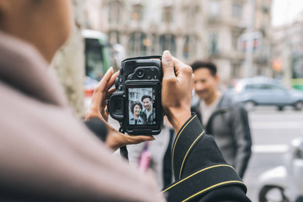 istock Asian tourist couple taking a picture with a camera 1063287100