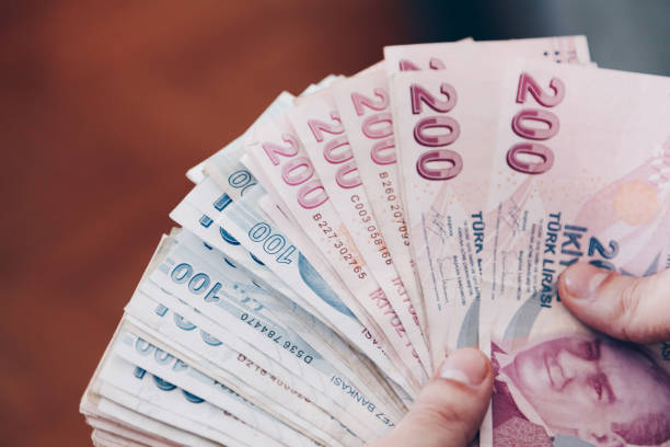 Turkish Lira Young man holding some one hundred and two hundred cash banknotes, Close up mediterranean ethnicity stock pictures, royalty-free photos & images