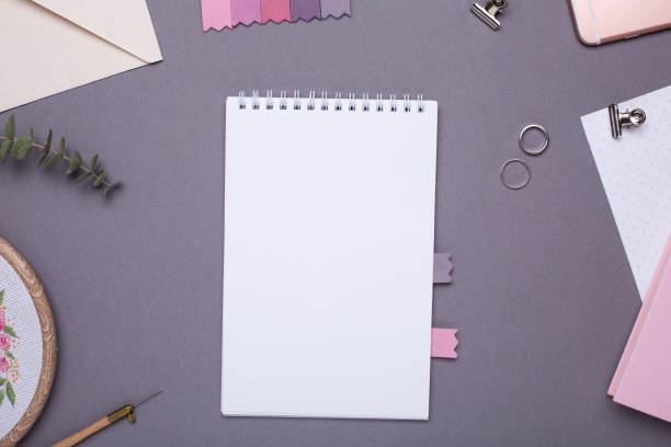 istock White notepad with pink book on grey background in vintage style 1063290236