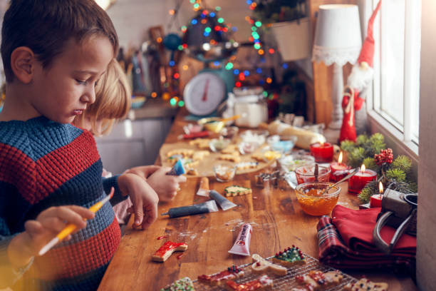istock Decorating Christmas Cookies with Icing and Sugar Pearls 1063292304
