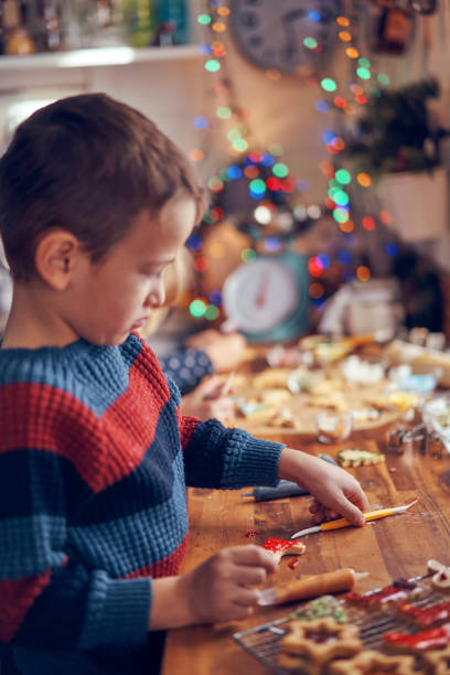 istock Decorating Christmas Cookies with Icing and Sugar Pearls 1063292360