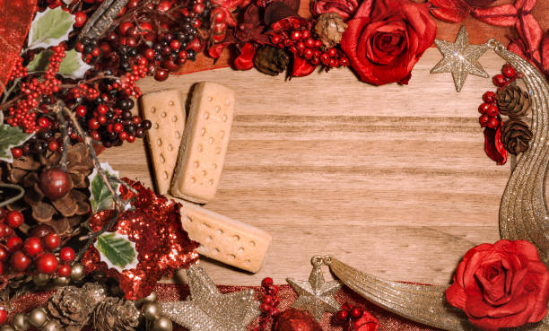 istock Christmas theme frame background on wooden surface with holly bush, decorations and shortbread biscuits. Food. Top view. Copy space 1063292414
