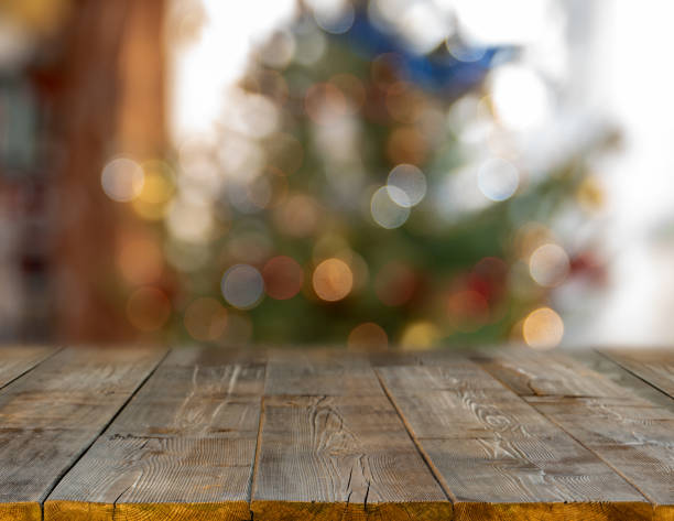 istock christmas table background with christmas tree out of focus 1063294408