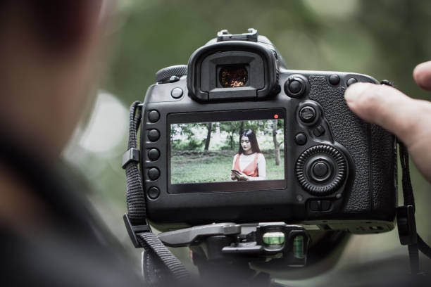 istock asian beauty vlogger review smartphone tutorial vlog viralclip on live streaming and behind cameraman Video or professional digital mirrorless on tripod for camera recording at outdoor 1063294622