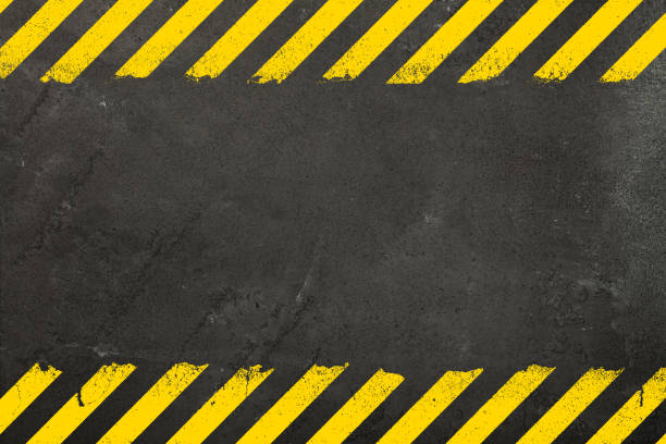 Concrete background with grunge hazard sign Dark grey concrete weathered wall background with yellow painted grunge hazard sign stripes and copy space at the bottom of photos stock pictures, royalty-free photos & images