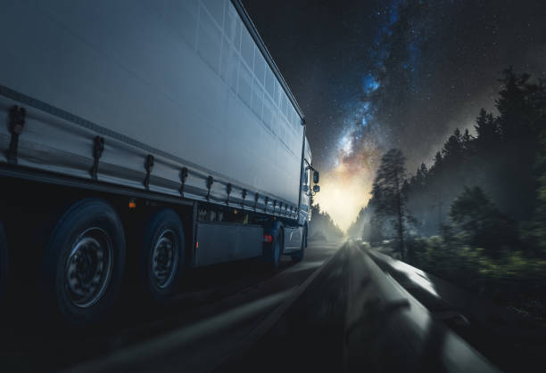 truck drives at night stock photo
