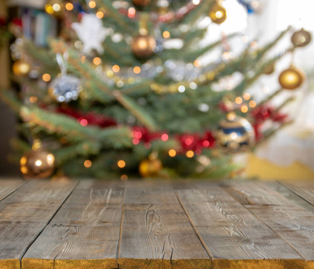 istock christmas table background with christmas tree out of focus 1063298696