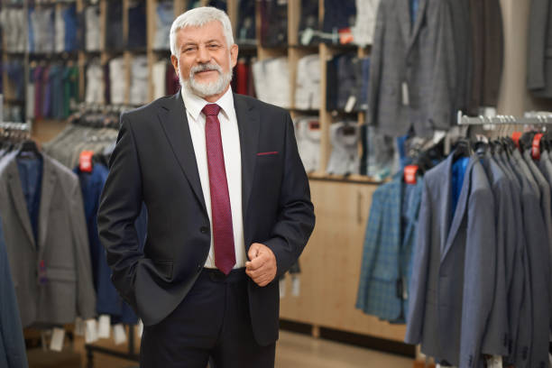 istock Old elegant man in grey costume with bow tie. 1063299030