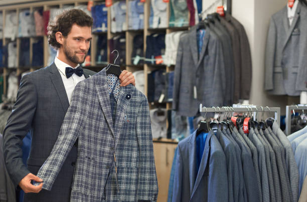 istock Gorgeous handsome man standing in store with grey jacket. 1063299048