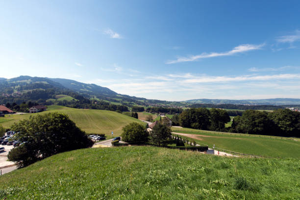 green pastures in the swiss village of gruyères, in the canton of fribourg, switzerland - fribourg canton imagens e fotografias de stock