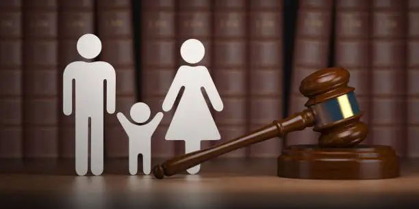 Familty law. Gavel and shapes of men, women and child with books. 3d illustration