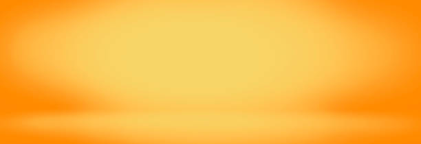 istock yellow and orange studio room background, bland banner and empty wall 1063299922