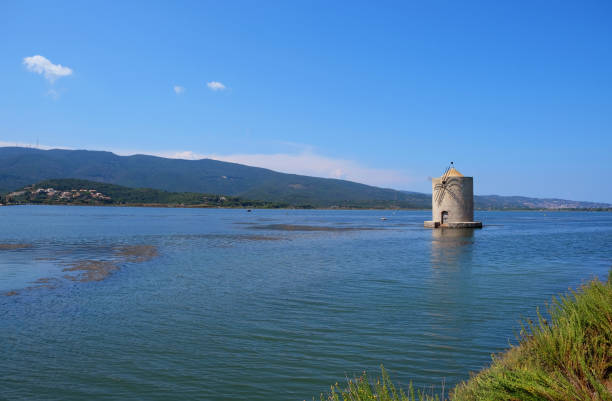 The windmill on the lagoon of Orbetello stock photo