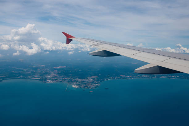 istock Airplane flying over Southeast Asia 1063303708