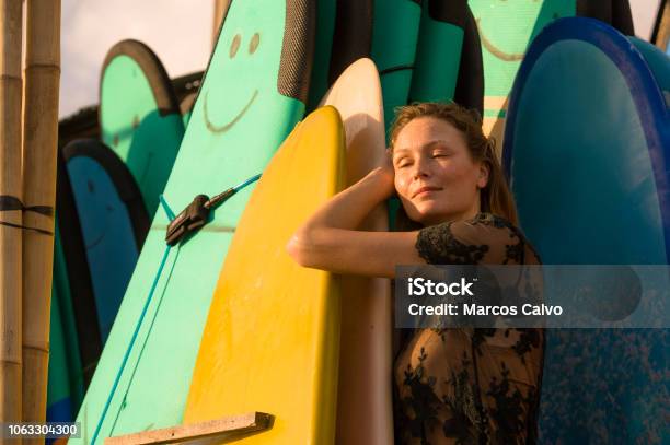 Head And Shoulders Portrait Of Young Beautiful And Happy Blond Woman Smiling Relaxed And Cheerful Posing With Colorful Surf Boards In The Background In Beauty Fashion And Summer Holidays Concept Stock Photo - Download Image Now