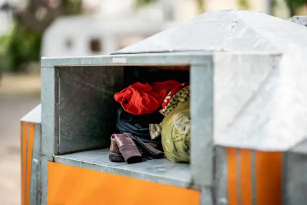 Photo of Worn clothes in a container