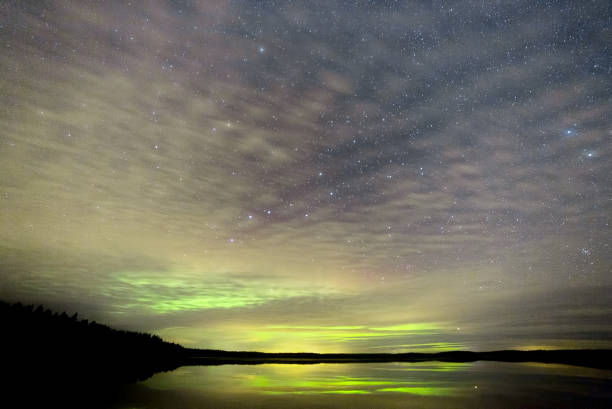 istock Northern Lights over Lake with clouds and stars 1063306276