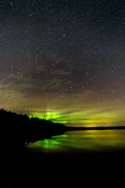 istock Northern Lights over Lake with clouds and stars 1063306318
