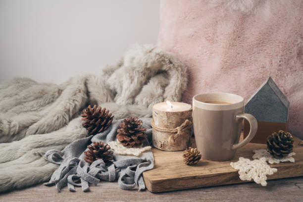 istock Hygge Scandinavian style concept with coffee cup, candles and pine corn 1063306898