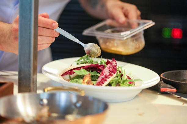 istock Pouring sauce over freshly made salad 1063310686