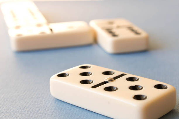 istock Playing dominoes on a blue background . Domino concept 1063311298