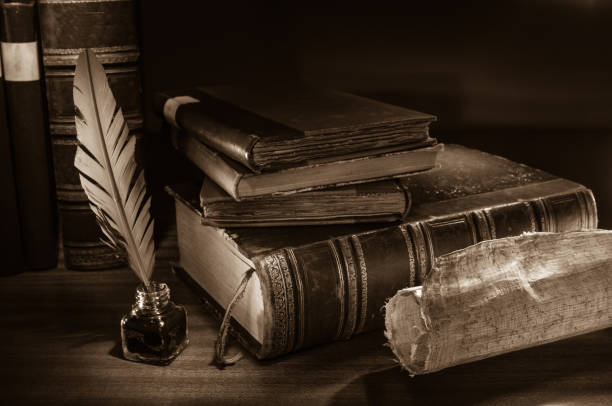 Quill pen and old books