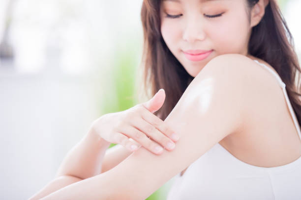 istock skin care woman applying lotion 1063317670