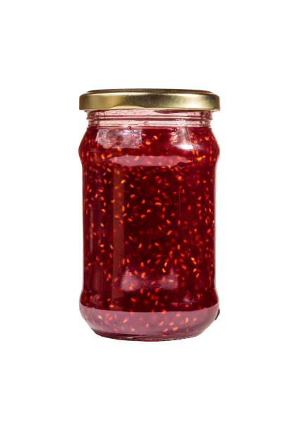 istock Raspberry jam in glass jar isolated on white background 1063317772