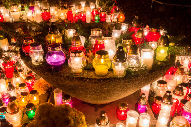 istock Candles burning at cemetery during All Saints' Day at night. 1063327614
