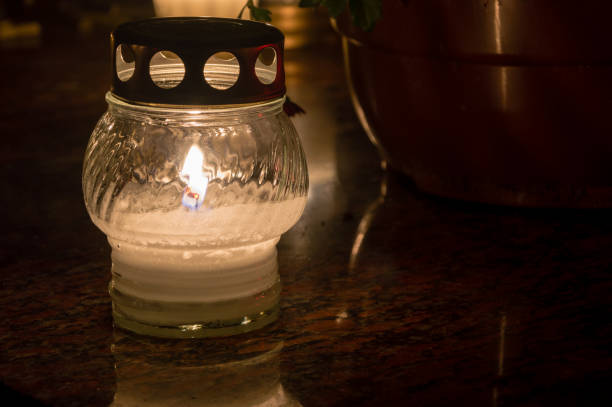 istock Lighted candle on the grave at All Saints' Day. 1063328758