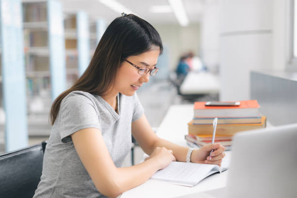 istock Asian Woman using laptop in the library. 1063328788