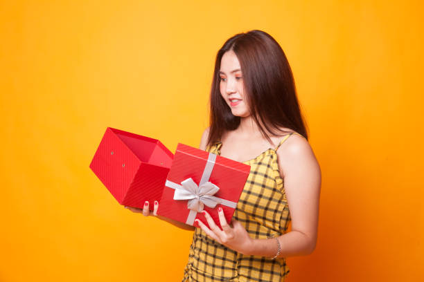 istock Young Asian woman open a gift box. 1063328988