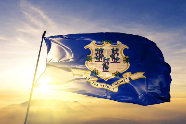 Connecticut state of United States flag textile cloth fabric waving on the top sunrise mist fog Connecticut state of United States flag on flagpole textile cloth fabric waving on the top sunrise mist fog connecticut stock pictures, royalty-free photos & images