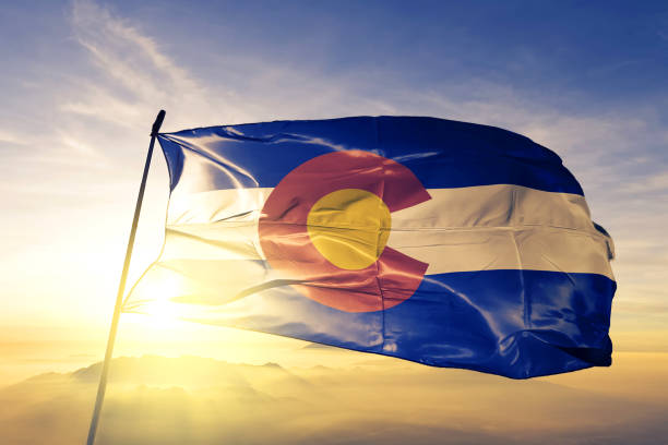 Colorado state of United States flag textile cloth fabric waving on the top sunrise mist fog Colorado state of United States flag on flagpole textile cloth fabric waving on the top sunrise mist fog colorado stock pictures, royalty-free photos & images
