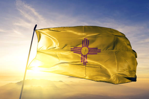 New Mexico state of United States flag textile cloth fabric waving on the top sunrise mist fog New Mexico state of United States  flag on flagpole textile cloth fabric waving on the top sunrise mist fog new mexico stock pictures, royalty-free photos & images