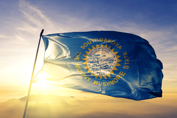 South Dakota state of United States flag textile cloth fabric waving on the top sunrise mist fog South Dakota state of United States flag on flagpole textile cloth fabric waving on the top sunrise mist fog south dakota stock pictures, royalty-free photos & images