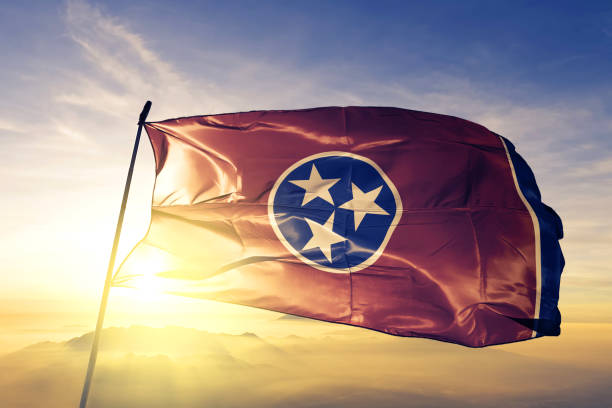 Tennessee state of United States flag textile cloth fabric waving on the top sunrise mist fog Tennessee state of United States flag on flagpole textile cloth fabric waving on the top sunrise mist fog tennessee stock pictures, royalty-free photos & images