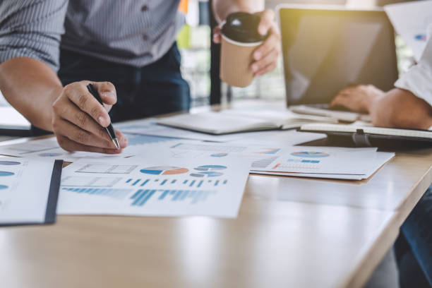 istock Business team colleagues discussing working analysis with financial data and marketing growth report graph in team, Meeting Talking Brainstorming Communication Concept 1063342310