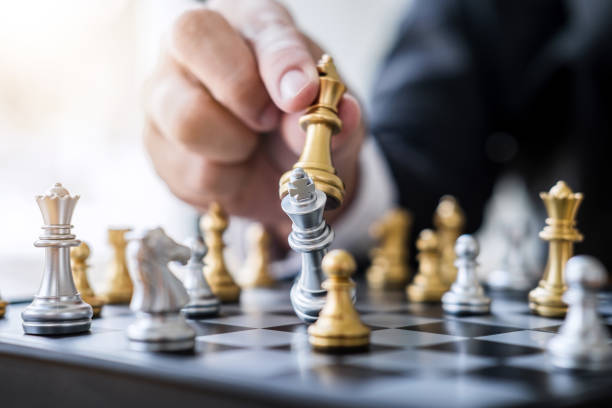 istock Hands of confident businessman playing chess game to development analysis new strategy plan, leader and teamwork concept for win and success 1063342724