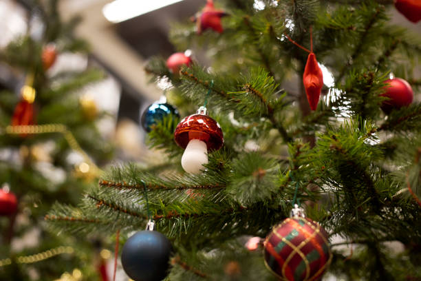 istock red bauble hanging from a decorated Christmas tree. 1063348898