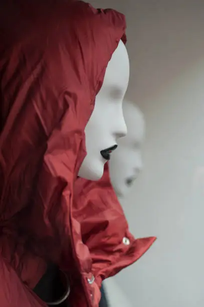 closeup of red winter coat on mannequin in fashion store showroom