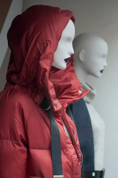 closeup of red winter coat on mannequin in fashion store showroom
