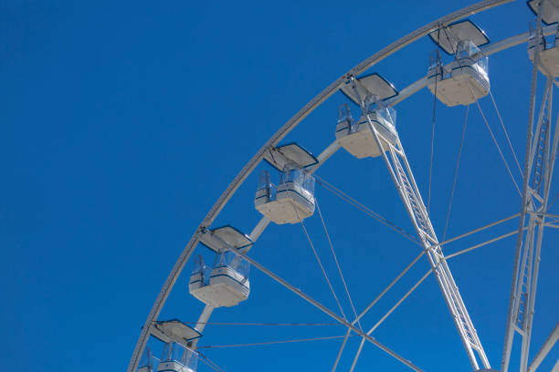 istock Giant ferris wheel with chairs, metallic structure, recreational element near the river 1063355868