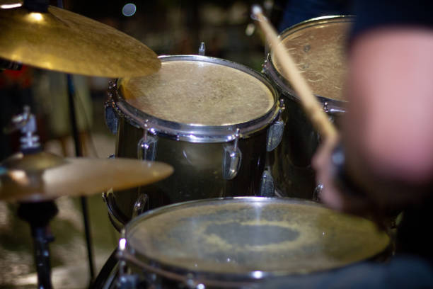 istock Hands of drummer with sticks and drums close-up on dark 1063356432