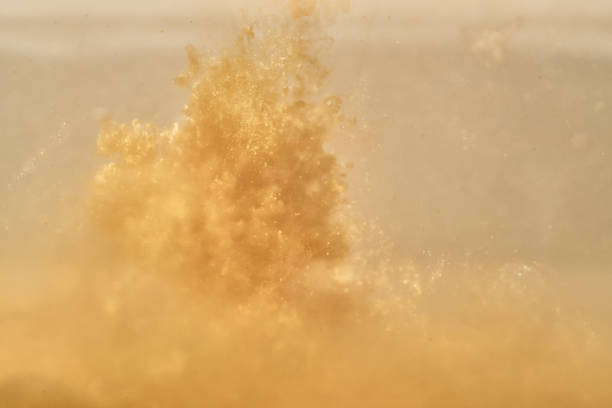 istock ink in water, golden wave, abstract background 1063361862